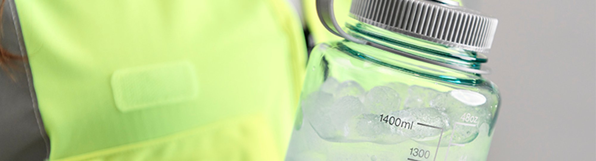 Factory worker in yellow vest with a water bottle Factory worker in yellow vest with a water bottle