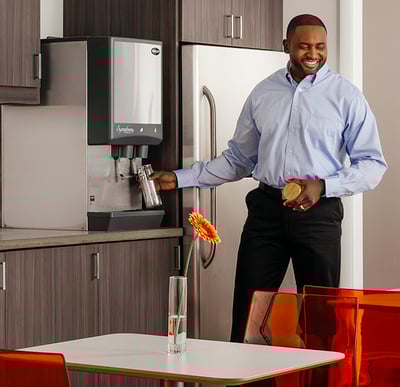 Symphony Plus countertop in a break room with employee getting water