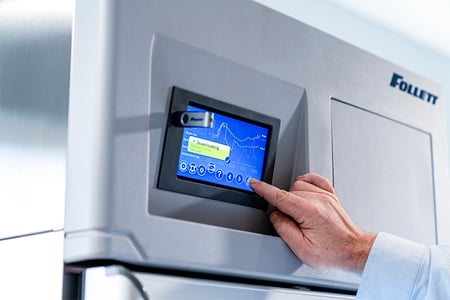 Man pressing buttons on refrigerator user interface
